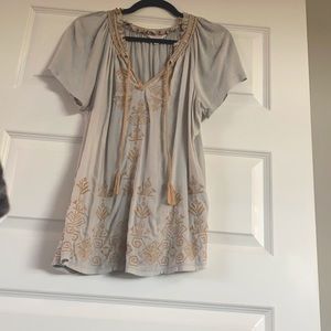 Shirt. Light blue with light brown detail.